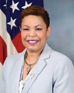 Ms. Taiwanna Smith standing in front of a flag.