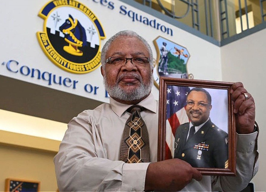 Black man holding a photo dod